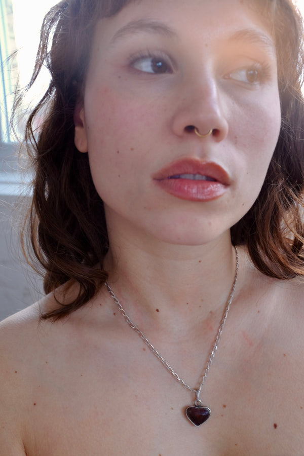 STERLING SILVER WITH RED RESIN ENCASED IN A HEART ON ANGULAR CURB