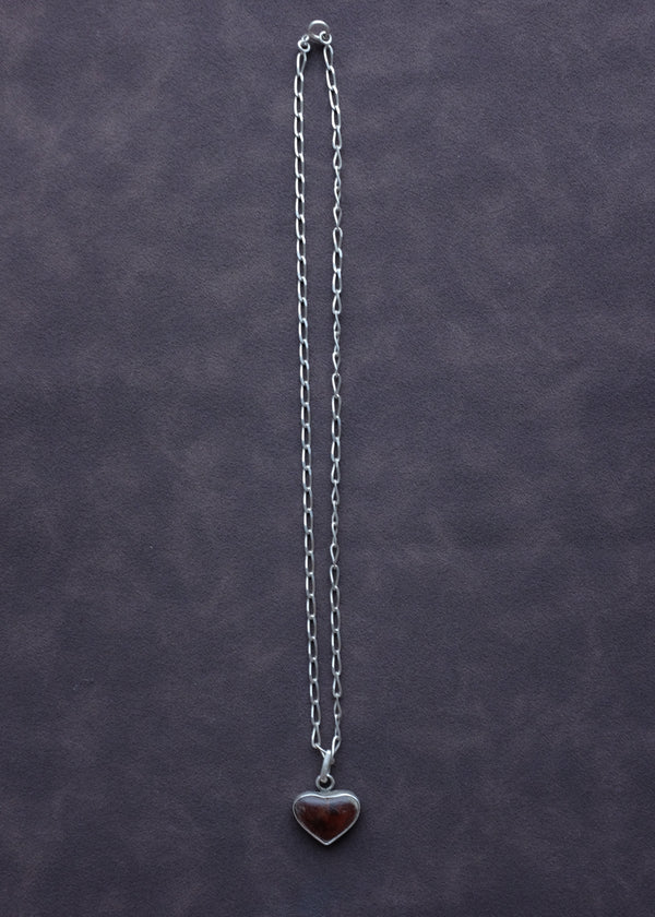 STERLING SILVER WITH RED RESIN ENCASED IN A HEART ON ANGULAR CURB