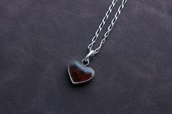 STERLING SILVER WITH RED RESIN ENCASED IN A HEART ON ANGULAR CURB