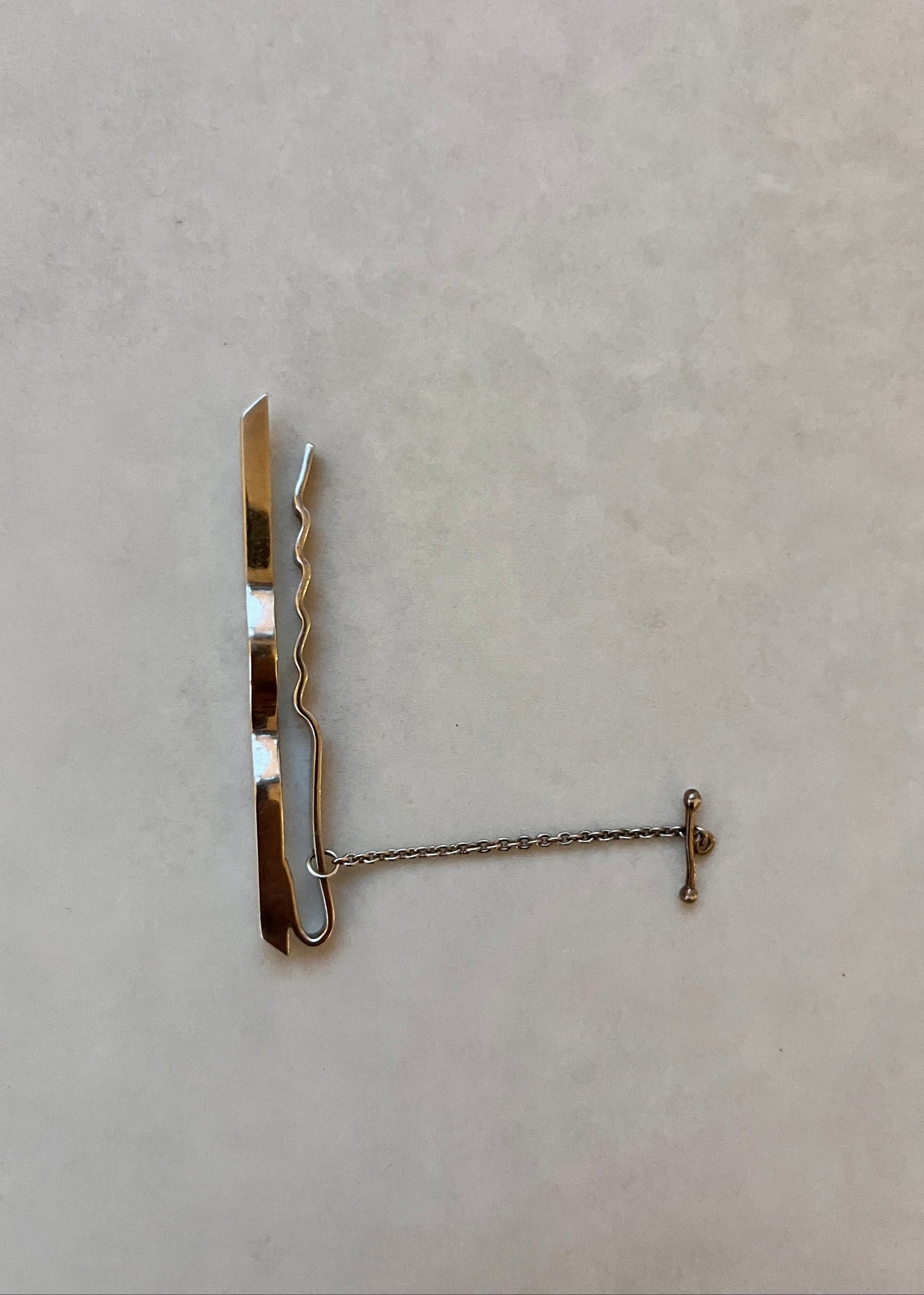 Metal swivel hook on a beige background